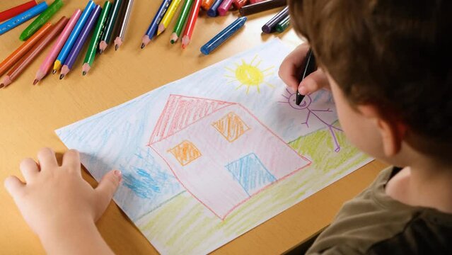 child draws house