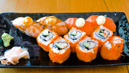 Various kinds of delicious sushi rolls with salmon and crab sticks