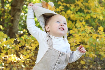 little girl in in autumn park