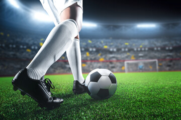 Soccer player in action on sport stadium background, kicking ball