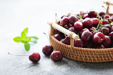 Fresh red cherries fruit on wicker tray