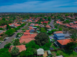 Obraz premium Panoramic Aerial Drone view of Suburban Sydney housing, roof tops, the streets and the parks