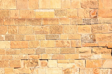 Big yellow wall made from stone bricks