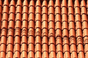 View of old Roof shingles background and texture. Orange wall background. Unique tiles. Roof top
