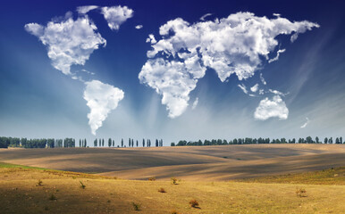 clouds in the form of a map of the world over the field. Travel and landscape concept. hilly field