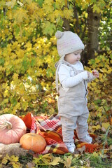 child with pumpkin