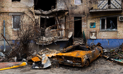 Fototapeta na wymiar Buildings and car damaged by Russian bombs.