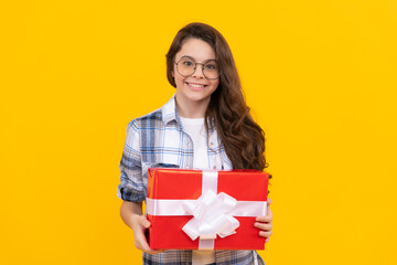 studio shot of smiling teen girl hold present. teen girl holding box of present. teen girl