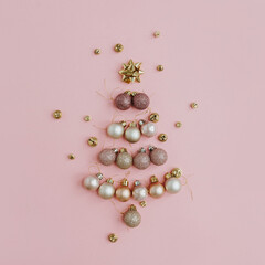 Christmas composition. Christmas tree made of colourful ball decoration on pink background. Flat lay, top view, copy space. New Year holiday card