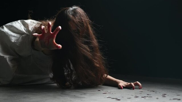 Happy Halloween day in Scary ghost woman. Asian ghost or zombie horror creepy scary have hair covering face and eye reach arm out at abandoned house dark room. 