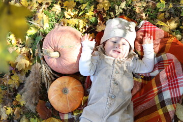child with pumpkin