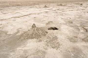 sandhills made by crabs on beach near salalah oman with sea in the background