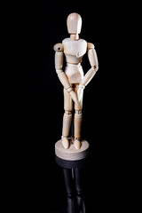 Image of wooden manikin on black background poses different posing