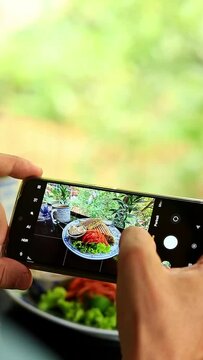 Vertical video of taking pictures of food with a smartphone for social media post