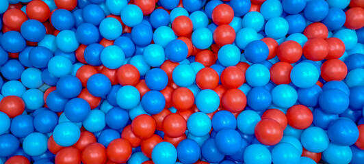 lot of blue and red plastic small children's balls for playing in the children's center.