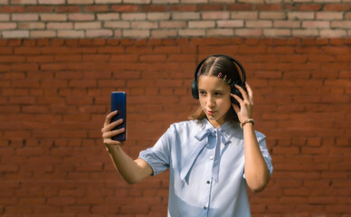 A teenager with a phone in his hands records a video for his blog on the Internet.