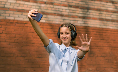 A teenager with a phone in his hands records a video for his blog on the Internet.