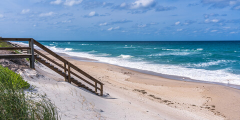 Wooden stairs to the ocean at a house in Florida, Melbourne Beach. Typical view of a beautiful beach in Florida