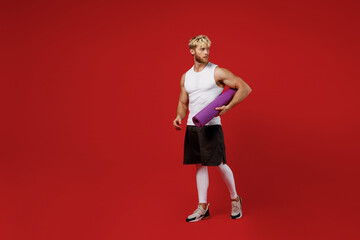 Full body young strong sporty toned sportsman man 20s wear white clothes spend time in home gym...