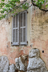 Wooden blinds of a window in an old building