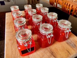 Small jars of homemade sweet chilli sauce made from home grown organic chillies. Sometimes called chilli jam.
