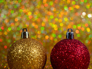 Christmas balls on a golden background. Christmas decoration with beautiful bokeh.