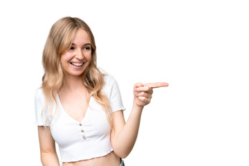 Young English woman over isolated background pointing finger to the side and presenting a product