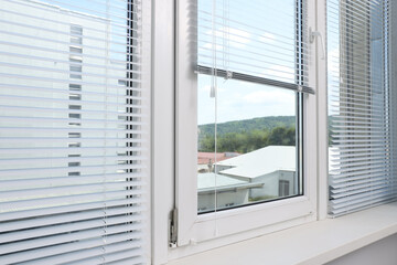 Window with horizontal blinds and white frame indoors