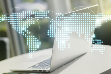 Abstract creative world map with connections on modern laptop background, international trading concept. Multiexposure
