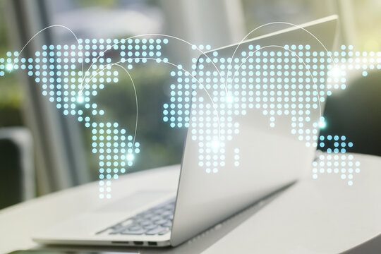 Abstract creative world map with connections on modern laptop background, international trading concept. Multiexposure