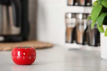 Kitchen timer in shape of tomato on white table indoors. Space for text - obrazy, fototapety, plakaty