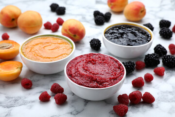 Different puree in bowls and fresh ingredients on white marble table
