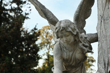Beautiful statue of angel at cemetery, space for text. Funeral ceremony