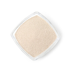 Granulated yeast in glass bowl isolated on white, top view