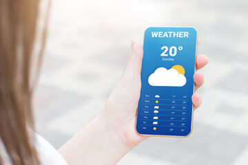 The girl checks the weather forecast in a mobile application
