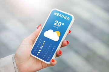 The girl checks the weather forecast in a mobile application