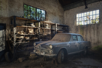 An old alfa romeo old timer stored in a garage