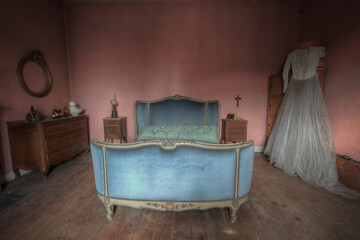 Antique Bedroom decorated in pink with a wedding dress