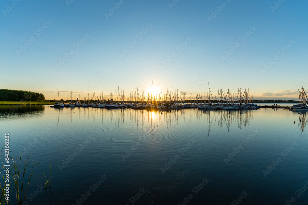 Wall mural sunset behind the harbor of the cospudener lake near leipzig