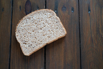 Slice of whole wheat bread on a wooden table