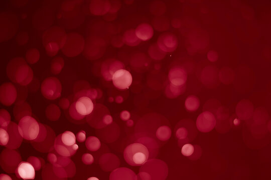 Red glitter vintage lights background.  red bokeh shiny on dark background.