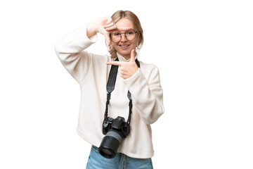 Young photographer English woman over isolated background focusing face. Framing symbol