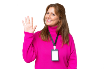 Middle-aged caucasian woman with ID card over isolated background saluting with hand with happy expression