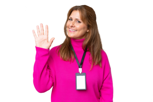 Middle-aged caucasian woman with ID card over isolated background saluting with hand with happy expression