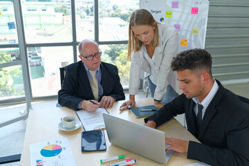 Businesswoman explains to colleagues a new project in the meeting room
