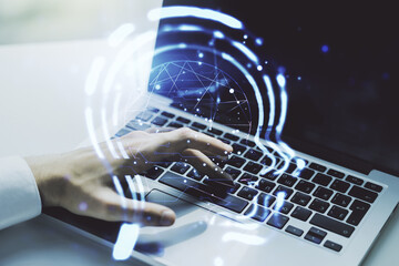 Creative artificial Intelligence concept with human head hologram and hands typing on laptop on background. Multiexposure
