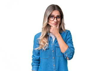 Young Uruguayan woman over isolated background having doubts
