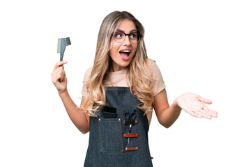 Young Uruguayan hairdresser woman over isolated background with surprise expression while looking...
