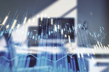 Abstract creative financial graph and modern desktop with pc on background, financial and trading concept. Multiexposure