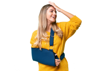 Young Uruguayan woman with broken arm and wearing a sling over isolated background smiling a lot